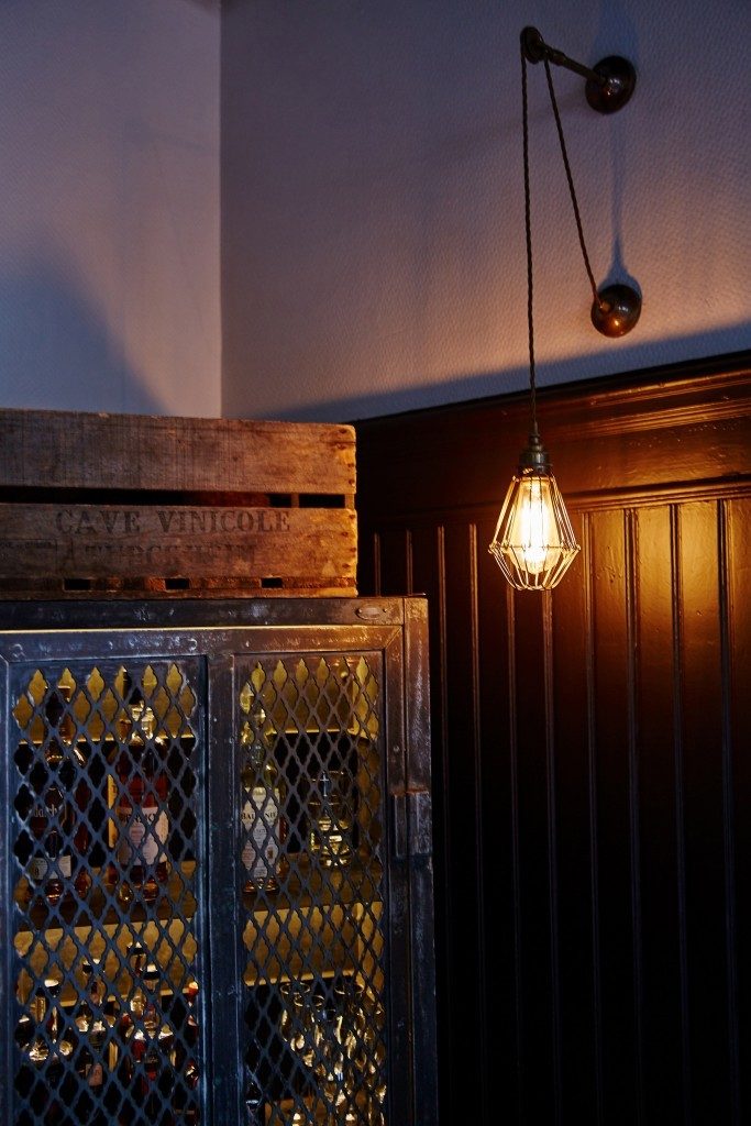 The Apoch pulley cage wall light from Mullan Lighting complements the golden glow from the Chulainn wall light in Les Innocents, Strasbourg