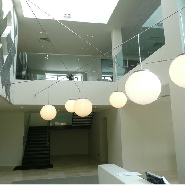Large opal globe pendant lights in this commercial space
