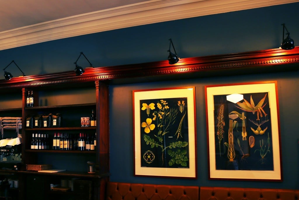 These picture wall lights from Mullan Lighting elegantly highlight the artwork and interior of this restaurant space. 