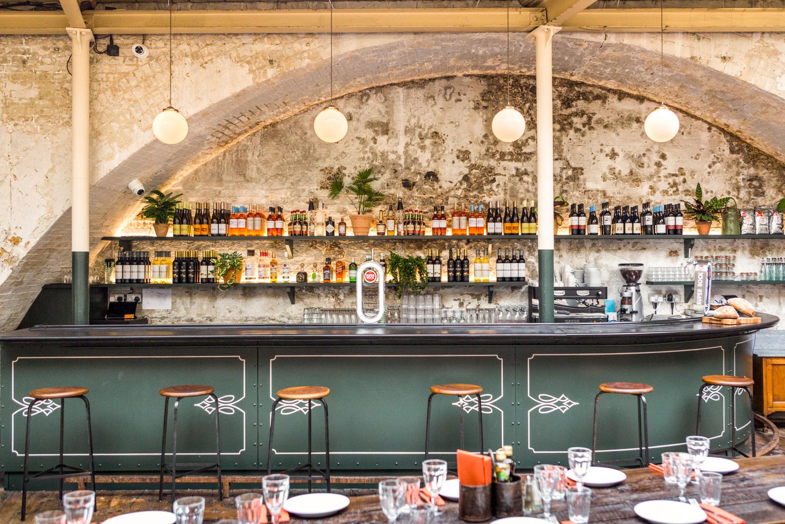 Globe Pendant Lights in this Rustic Portuguese Restaurant in London