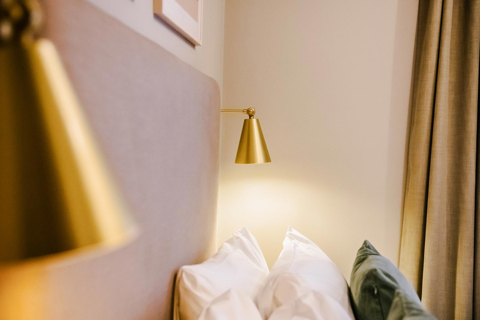 Brass Wall Lights Dress the Bedroom Suites of this Serviced Aparthotel