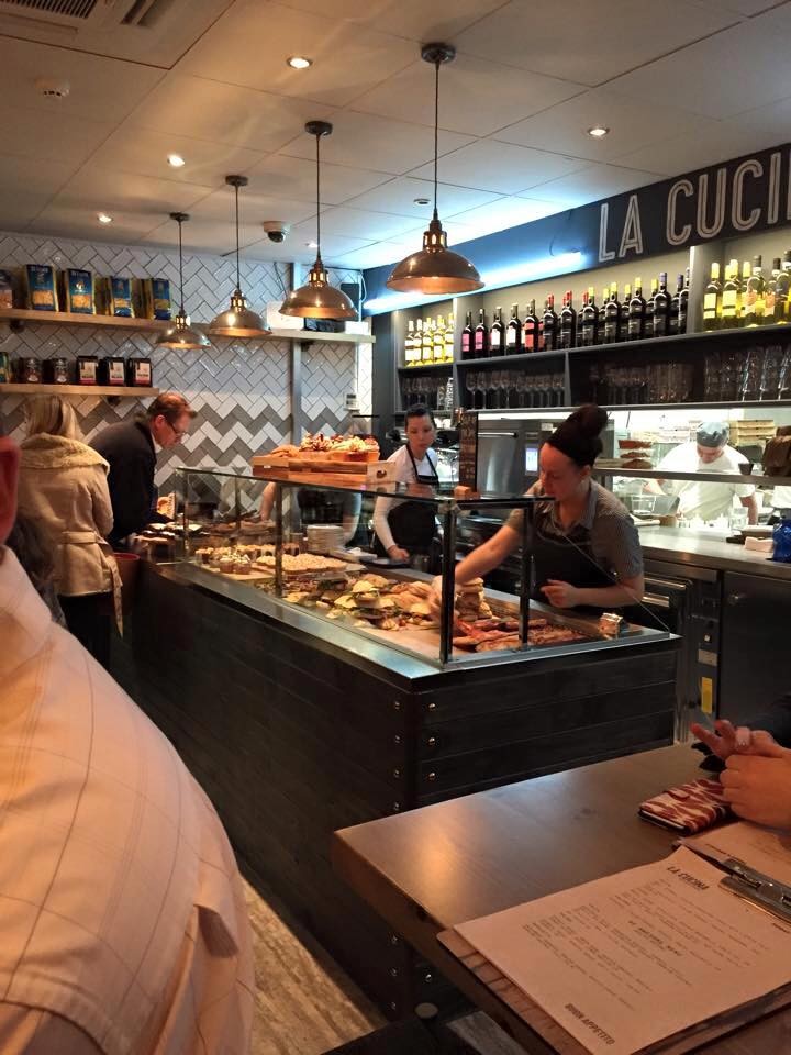 Pendant lighting from Mullan Lighting gently illuminate the tasteful selection of food at La Cucina 