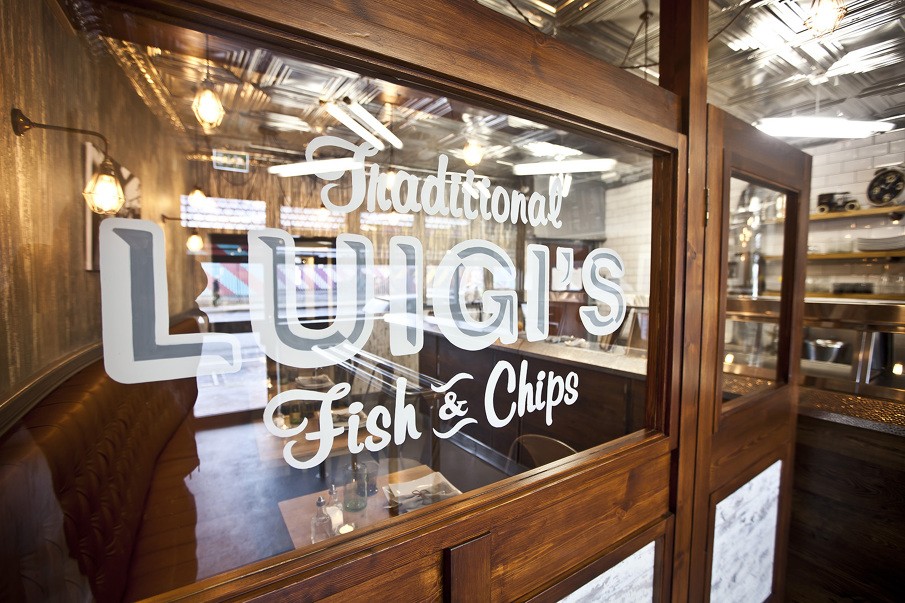 Industrial light fixtures add warmth to Luigi's traditional fish and chip shop in Limerick