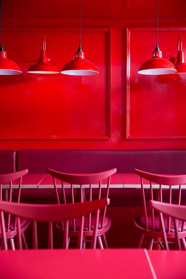 Powder-coated in red, these Osson pendants add an industrial style to this London restaurant