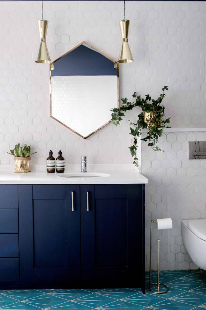 Our Amias pendants in a polished brass finish add a subtle golden glow to this bathroom. 