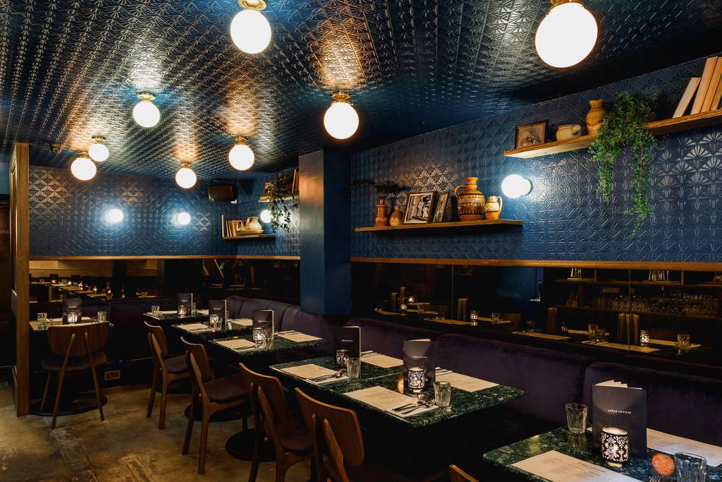 Flush ceiling lighting by Mullan Lighting feature in this restaurant space. 