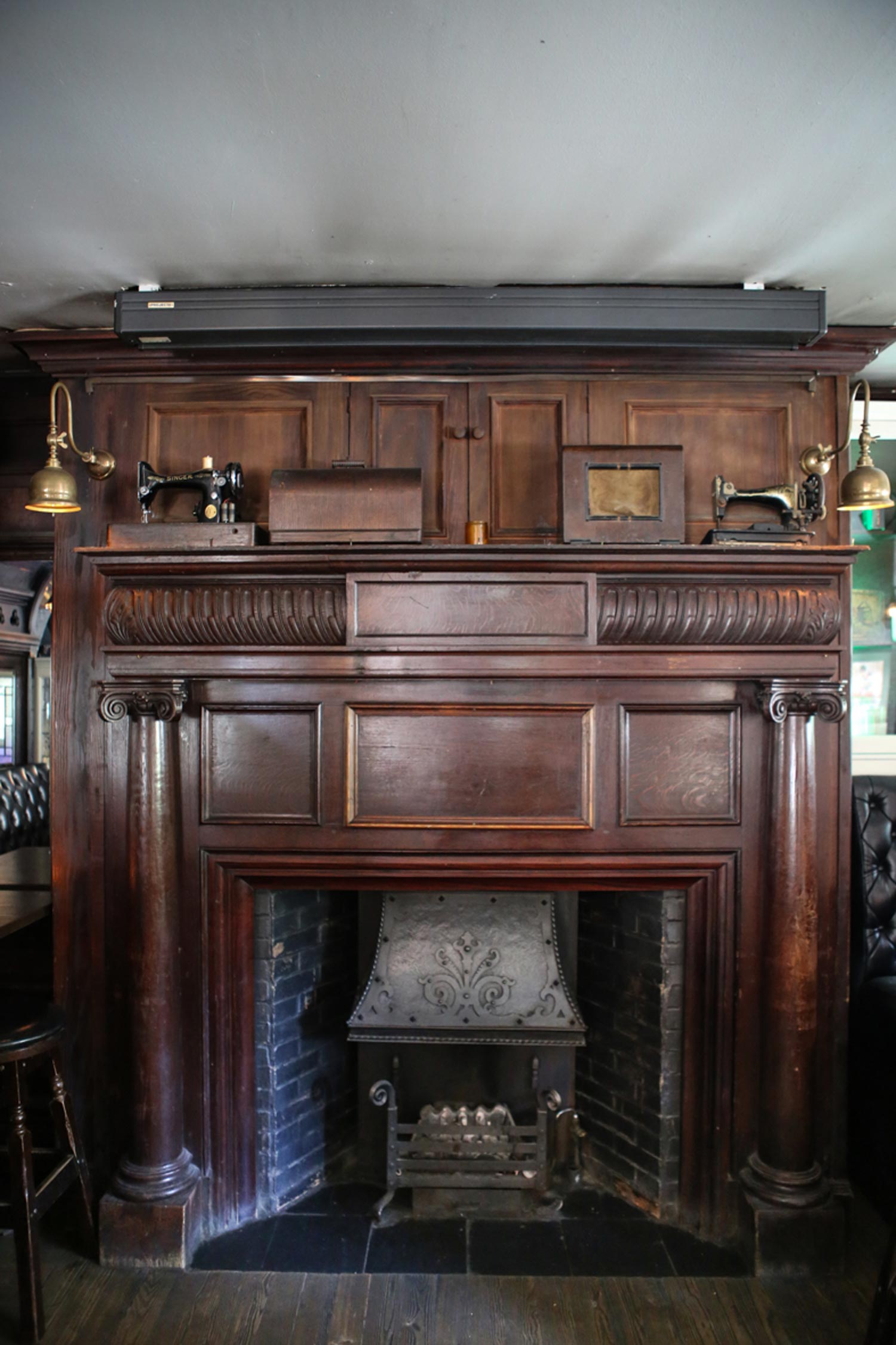 Our Apia wall lights finely sit on the grand wooden fireplace