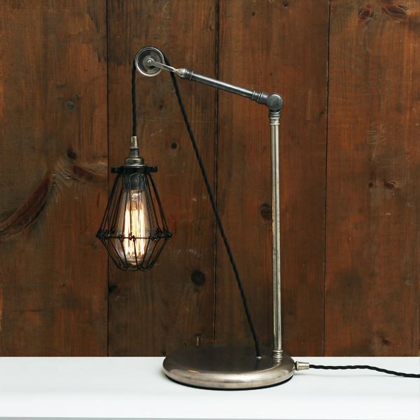 Inspired by industrial style, the Apoch pulley cage table lamp is finished off with an industrial style cage perfect for your vintage industrial or steampunk décor. This pulley table light is the perfect addition to any den or office. This adjustable table lamp lives at the intersection of utility and style, allowing the user to add their individual character to the lamp.