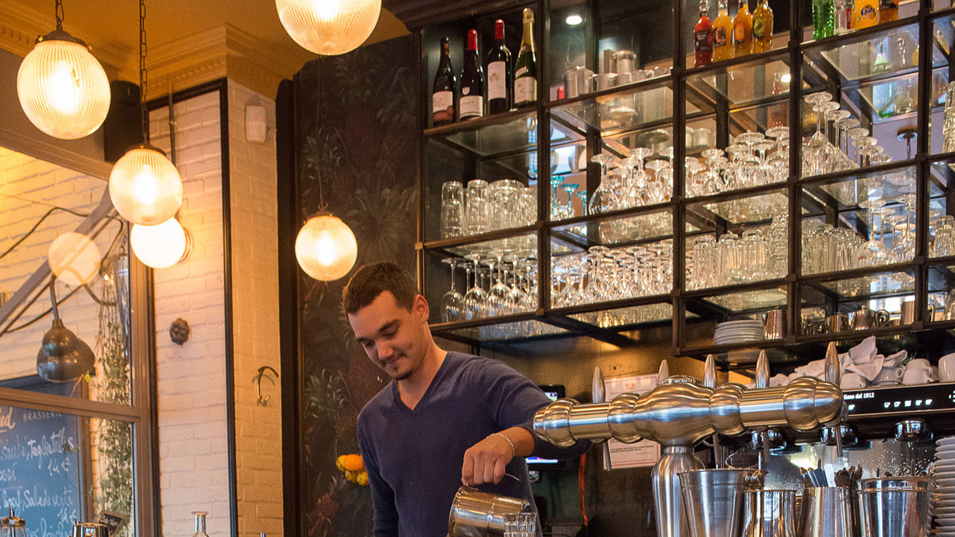 Holophane glass shades help create warm tones in Manfred café, Paris