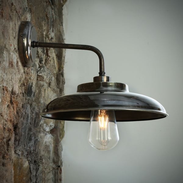 The Darya wall light from Mullan Lighting is an industrial-style light fixtures that features a partially exposed decorative filament bulb. 