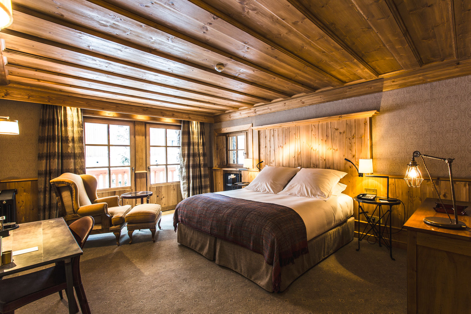Industrial lighting helps create a home away home in this Alpine mountain hotel