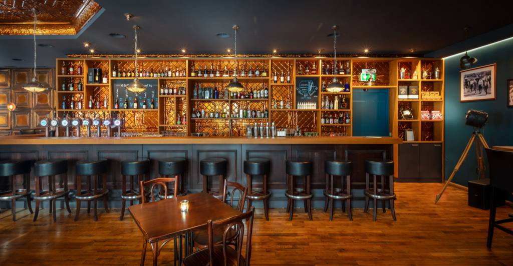 Vintage Marlow cage pendant lights suspended above the bar counter of Al Capone restaurant in St. Gallen, Switzerland