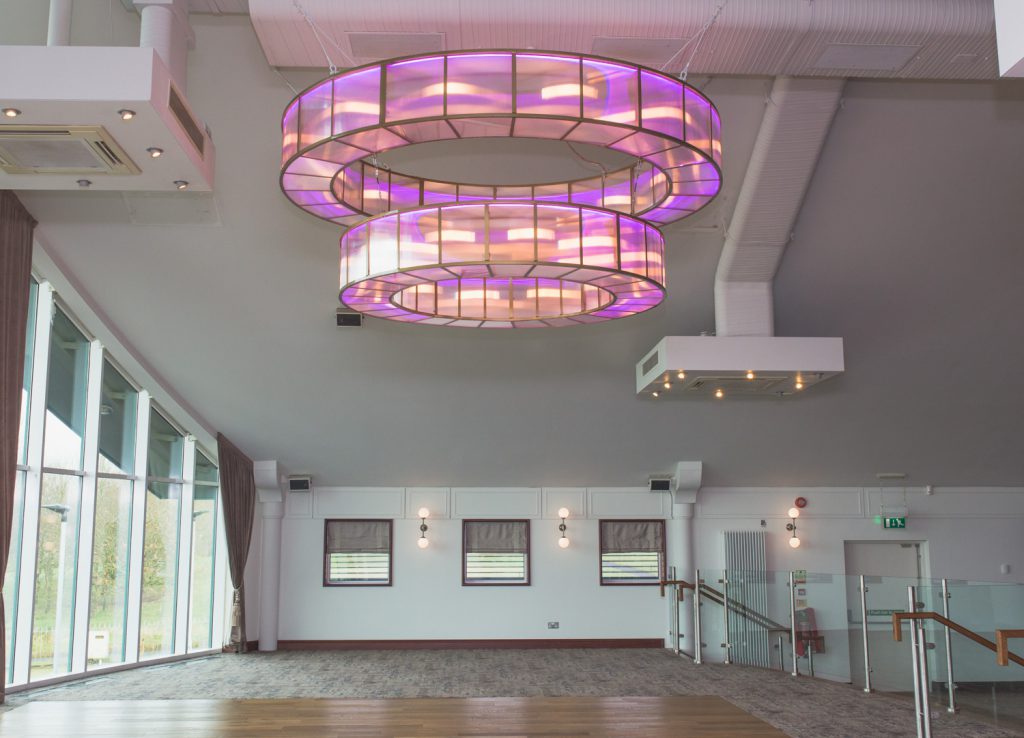 The bespoke chandelier in the Foyle Golf Centre changing light colour to a purple hue