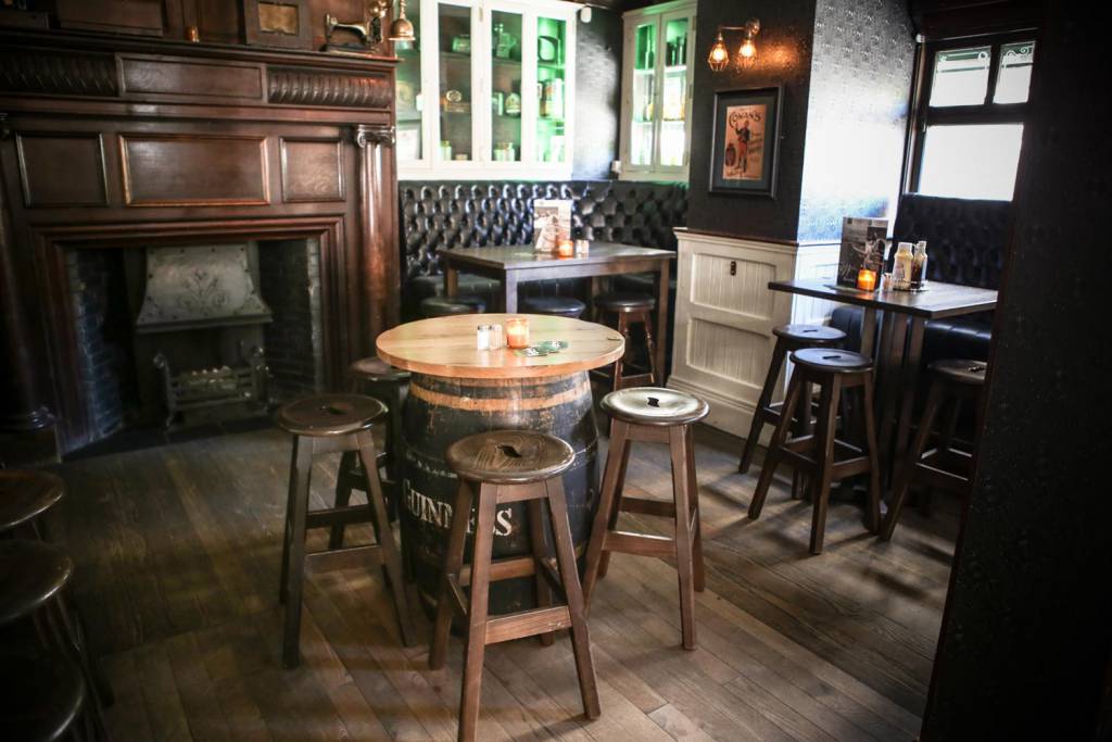 The old-style wooden decor is teamed with unique beer barrel style tables and leather seating booths