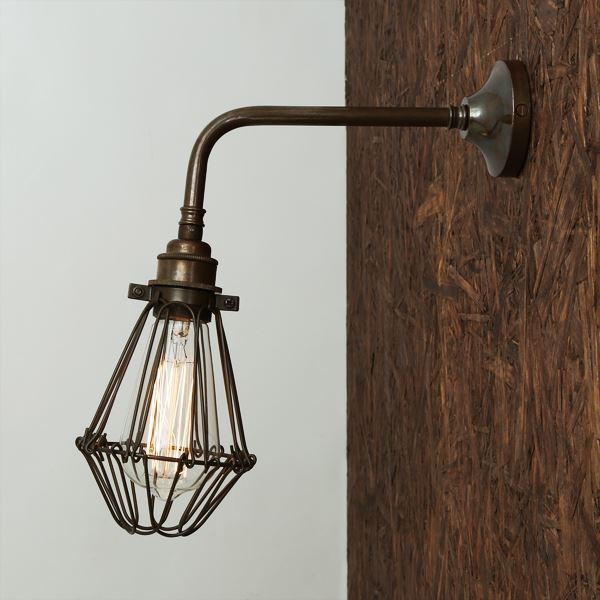 The Praia vintage cage wall light adds an industrial appeal and creates a very dynamic design statement to any room decor. This swing arm wall light is perfect for an industrial or rustic style living space, and also makes a wonderfully eclectic accent in a modern space.