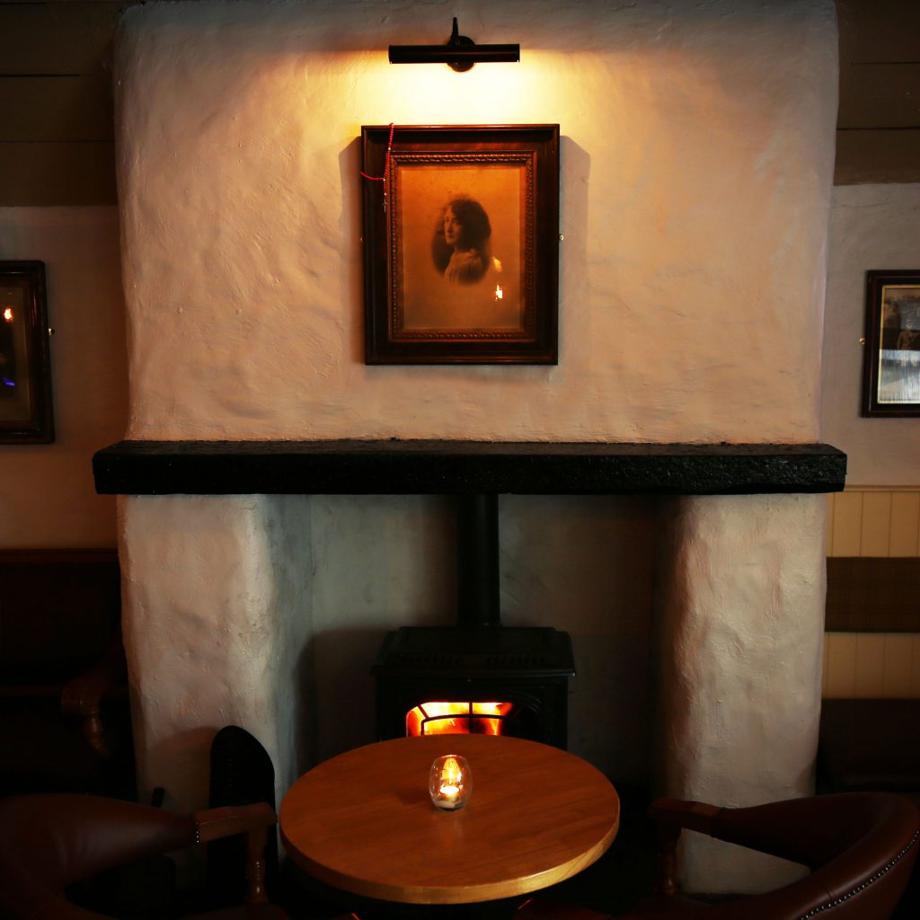 Our Elle picture light helps create a cosy atmosphere above the fireplace of The Lime Kiln, Meath