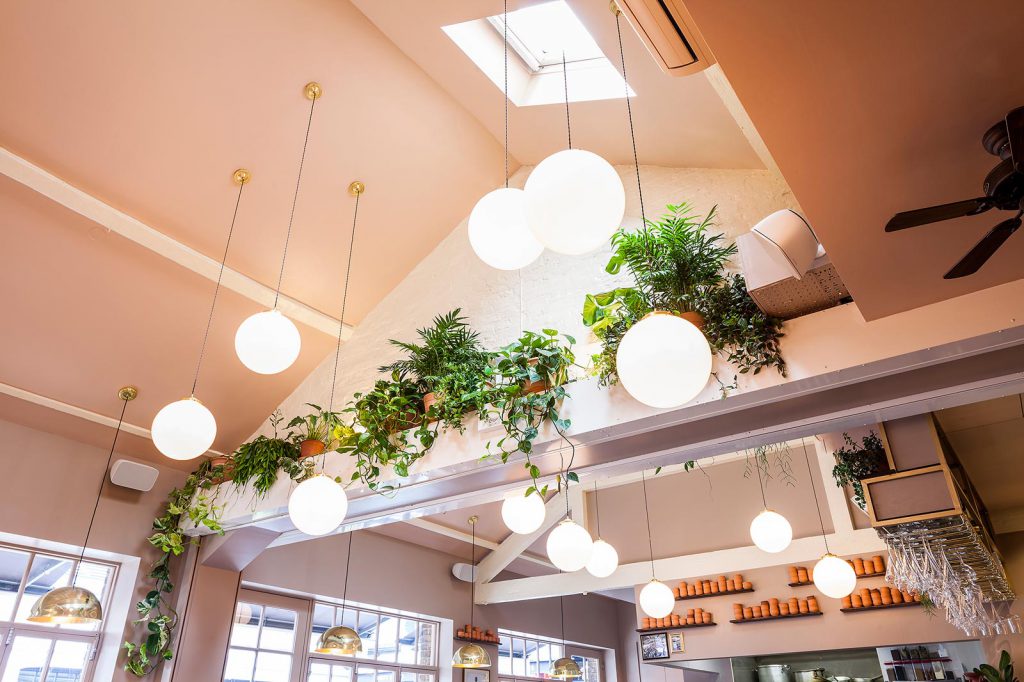 Ceiling detail at Darjeeling Express which features our Gentry glass globe pendants