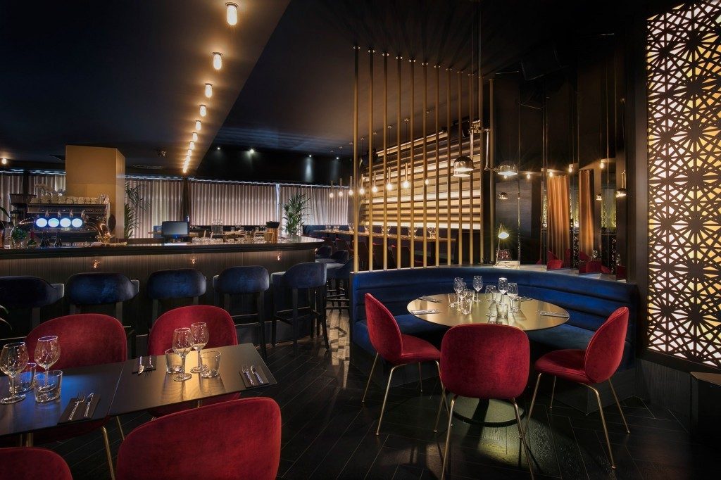 A row of ceiling lights directs customers through the restaurant