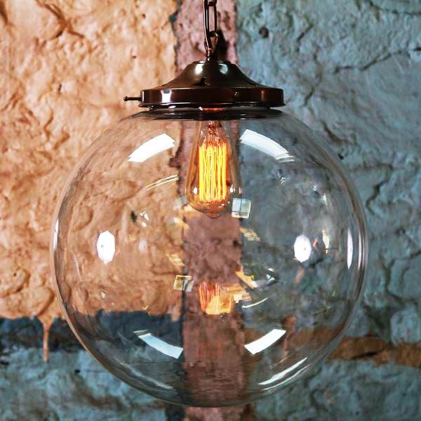 Evoking early 20th-century industrial lighting, the Riad 35cm clear globe pendant retains the classic lines and exposed hardware of the originals. 