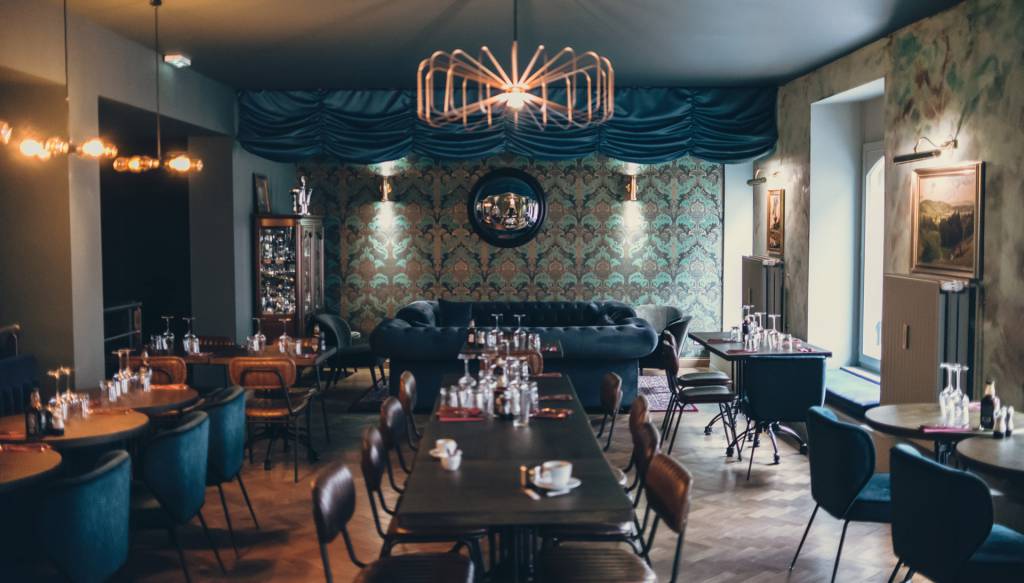 Our Dublin brass picture lights highlights classic oil paintings in this restaurant design 