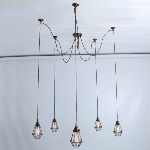 Mullan Lighting produced the Praia cage pendant light which features five separate Edison-style bulbs and brass cage. 