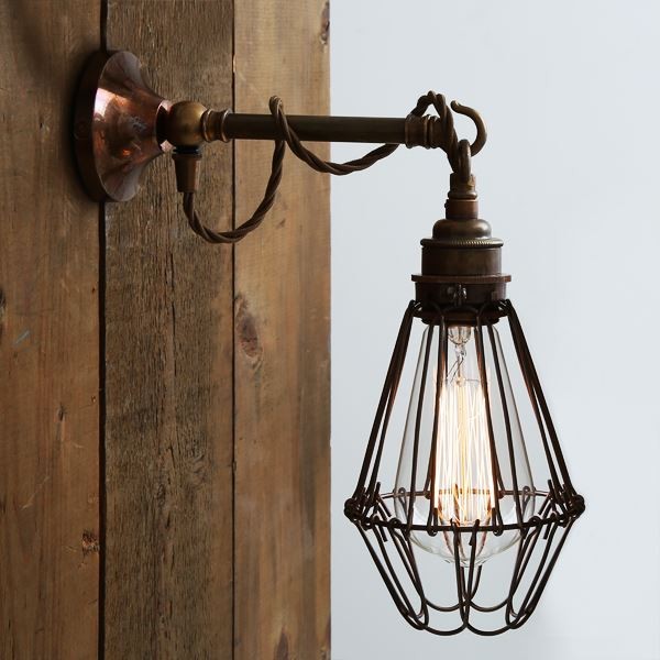 The Edom industrial cage wall light from Mullan Lighting oozes an industrial, vintage charm with a protective brass cage. 