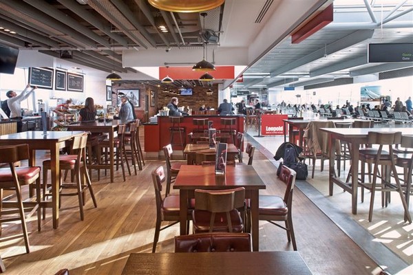 Industrial lighting fixtures from Mullan Lighting create a warm lighting effect, perfect for lighting a pub.