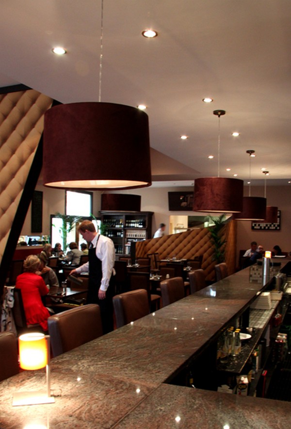 We designed these bespoke lampshades in a rich maroon to add a luxurious touch to Alexis Bar & Grill 