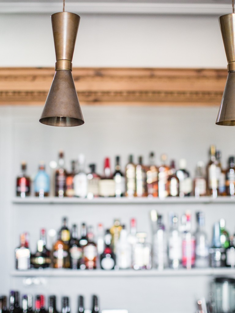 This British coastal restaurant features our Cairo contemporary pendant lights in a brass finish 