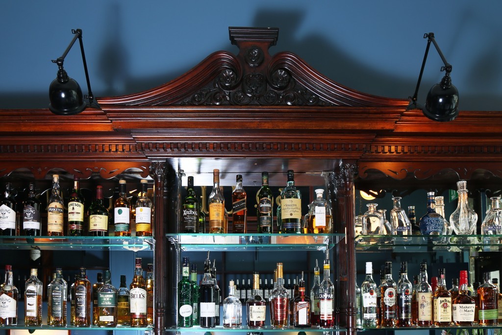 Picture lights from Mullan Lighting proudly sit on the wooden décor of Delahunt, adding a vintage touch to the space.