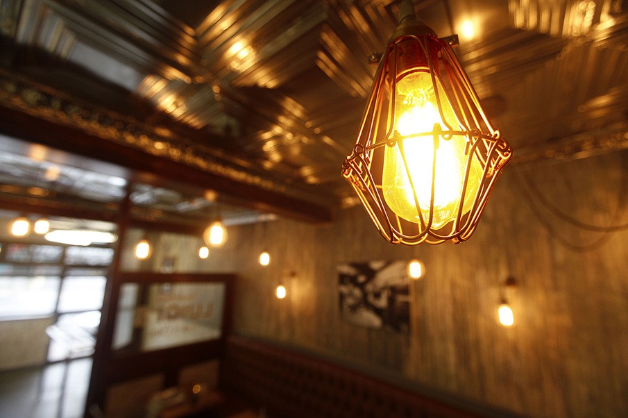 Tullio O. Design used industrial pendant light fixtures from Mullan Lighting to add a sense of warmth to this fish and chip shop in Limerick
