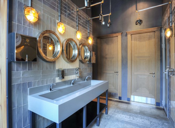 These Adoo marine wall lights from Mullan Lighting add a nautical touch to this bathroom space 