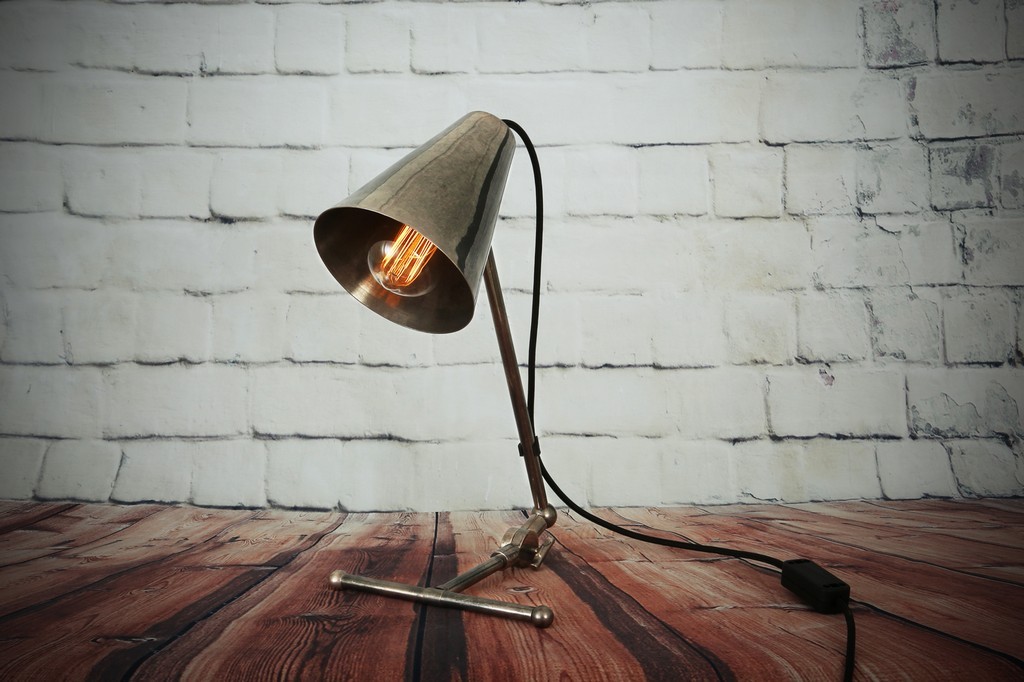 A chic addition to a modern loft, the Comoro table lamp offers ideal task lighting.