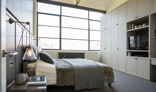 Chiswick Green Studios loft apartment features a monochrome colour scheme that is gently complemented by Rigale coolie pully lights from Mullan Lighting