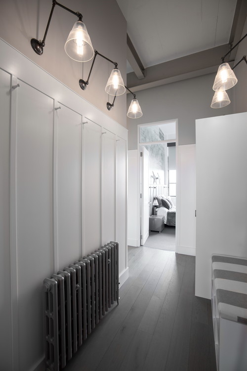 Lyx adjustable poster lights from Mullan Lighting provide a soft, subtle glow in this hallway of Chiswick Green Studios loft apartment